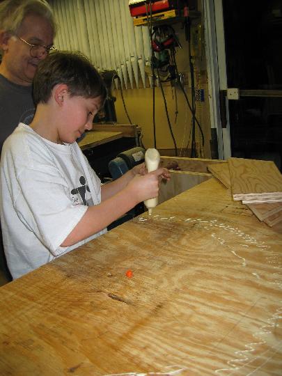 IMG_5235.jpg - Applying glue to one side of the wheel.